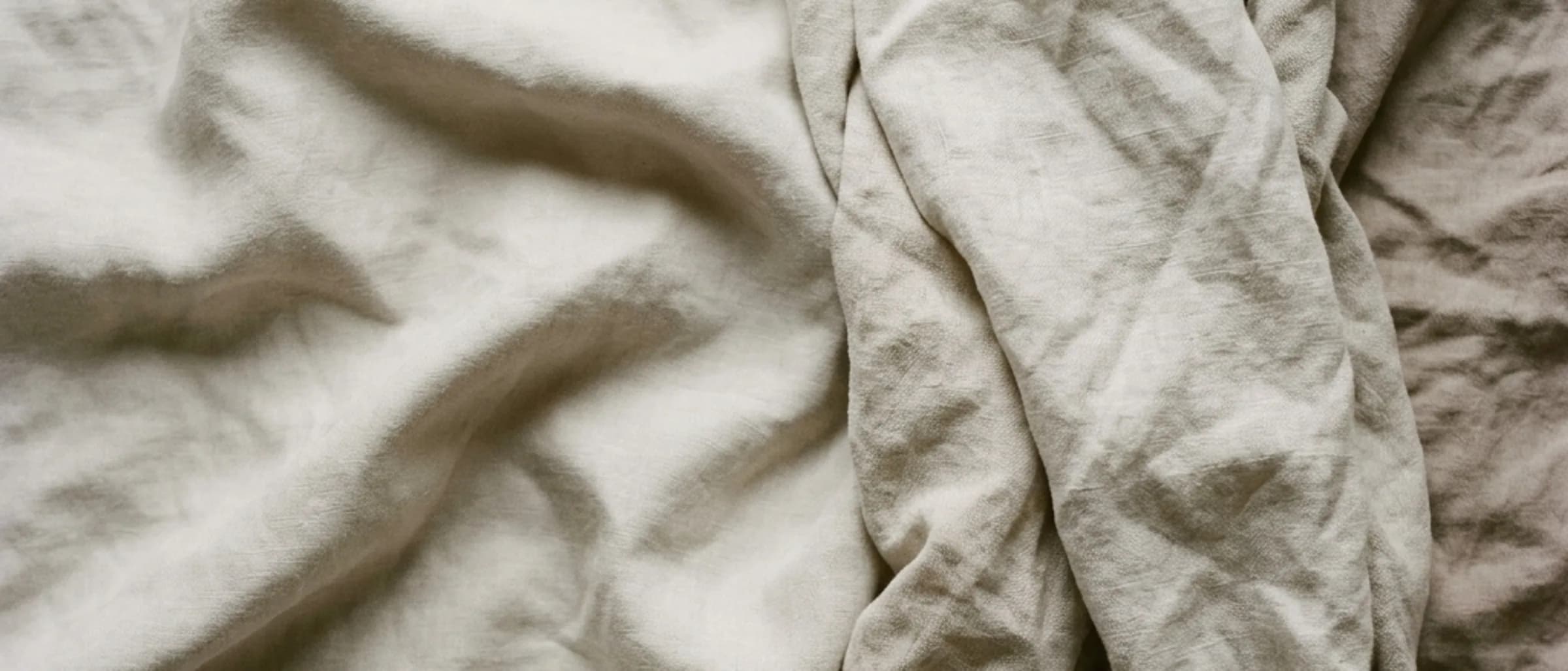 Soft daylight falling across clean, folded linen fabric.
